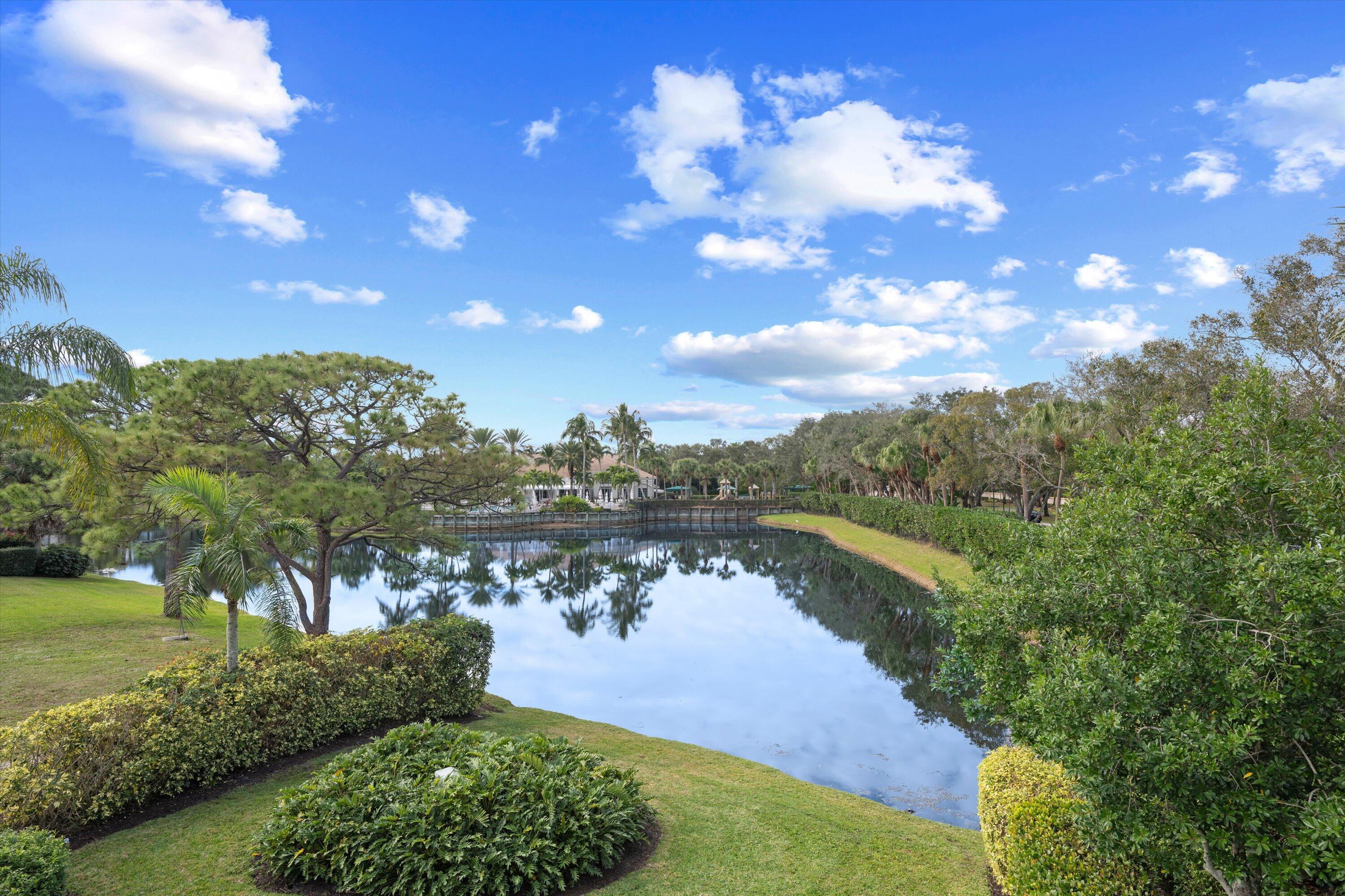 113 Caballo Lane Jupiter, FL 33458 - Photo 50 of 51 a view of a lake with a yard