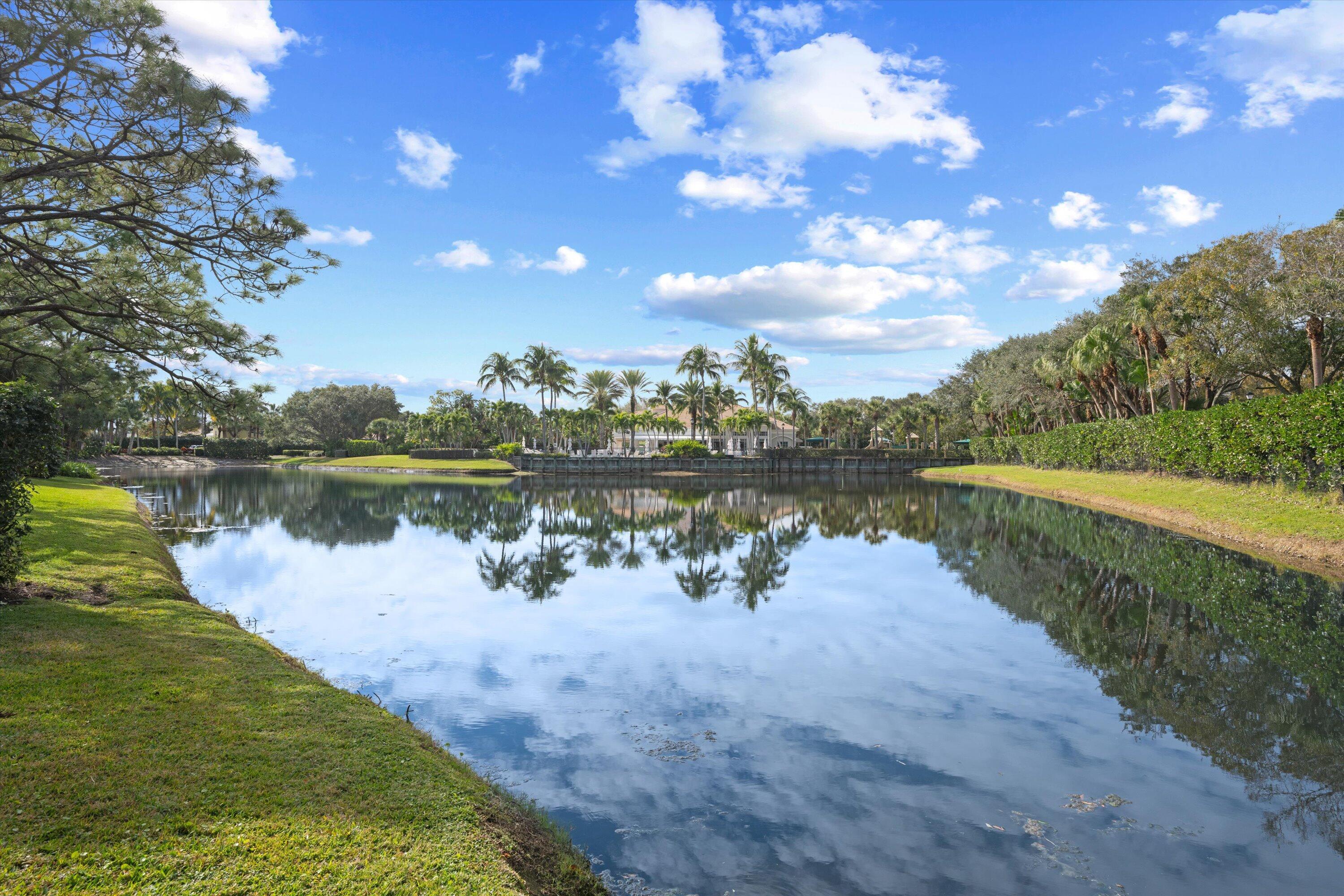113 Caballo Lane Jupiter, FL 33458 - Photo 51 of 51 a view of a lake with houses in the back