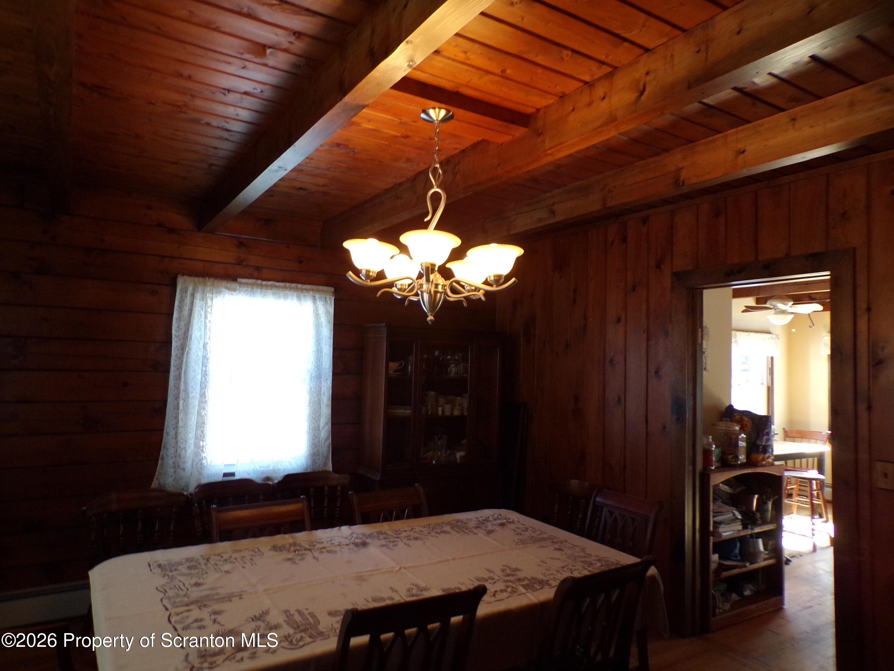 2590 Potter Hill Road Thompson, PA 18465 - Photo 14 of 43 a dining room with a table and chairs