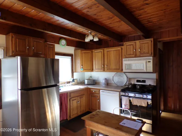 a kitchen with stainless steel appliances granite countertop a refrigerator and a stove