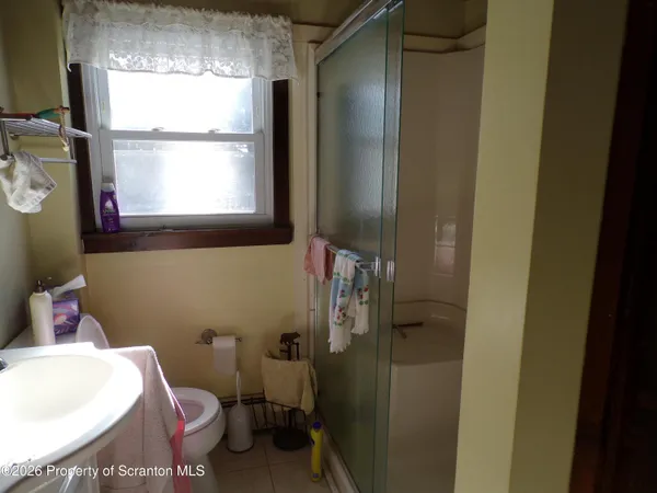 a bathroom with a toilet sink and a window