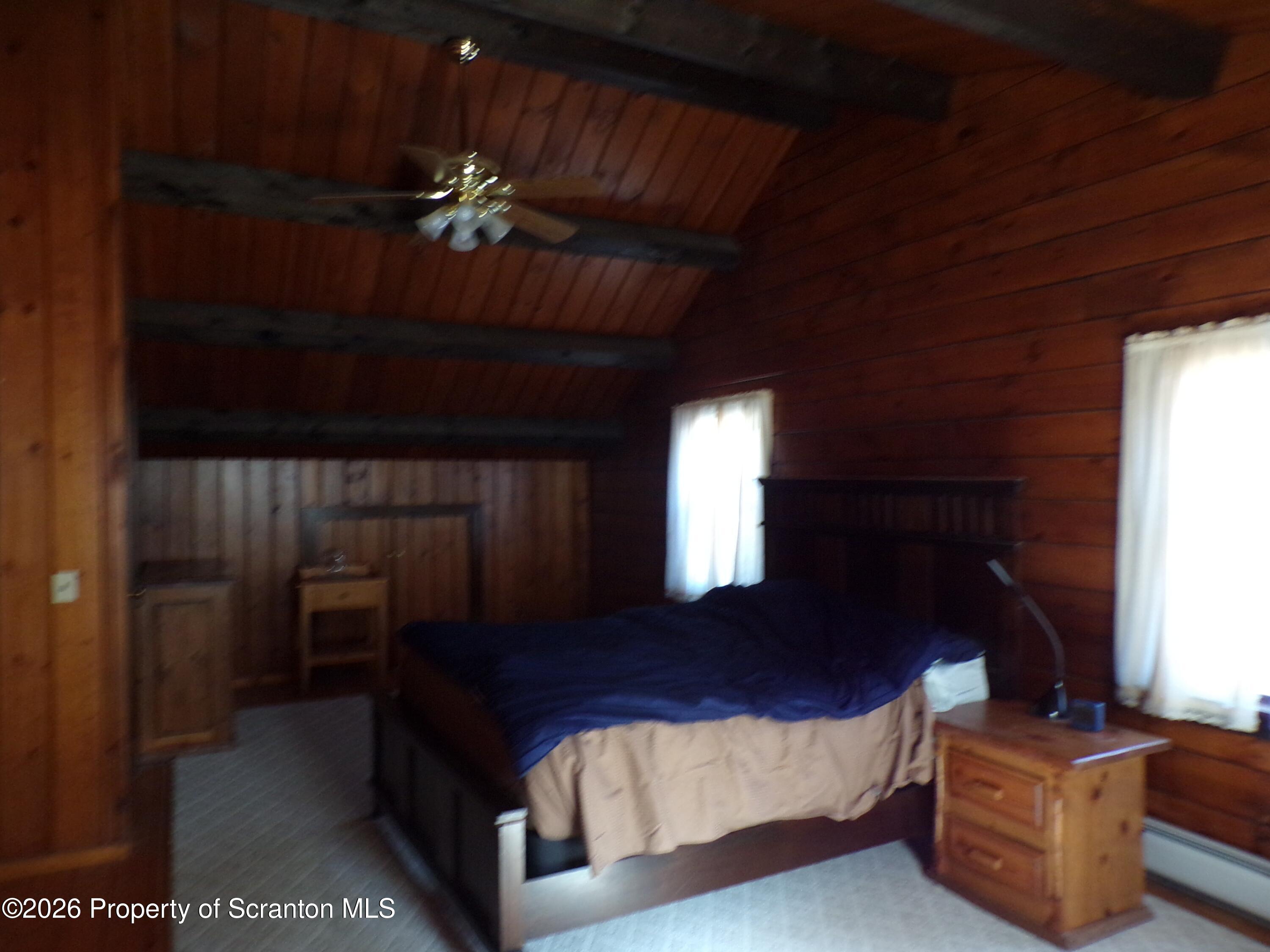 2590 Potter Hill Road Thompson, PA 18465 - Photo 22 of 43 a bedroom with furniture and wooden floor