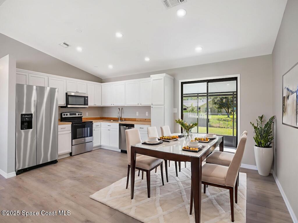 274 Trilby Road Southwest Palm Bay, FL 32908 - Photo 12 of 38 a dining room with furniture and a kitchen view