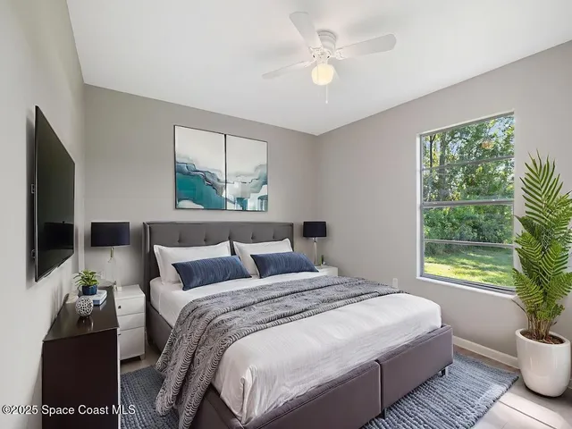 a bedroom with a large bed and a window