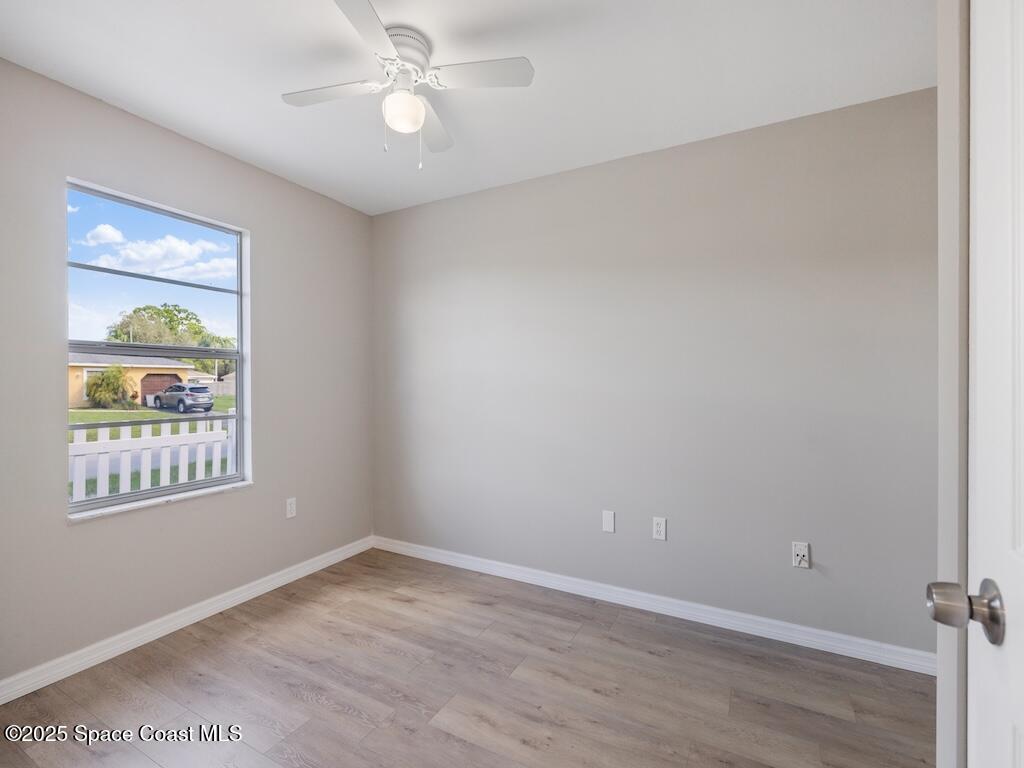 274 Trilby Road Southwest Palm Bay, FL 32908 - Photo 17 of 38 an empty room with a window and ceiling fan