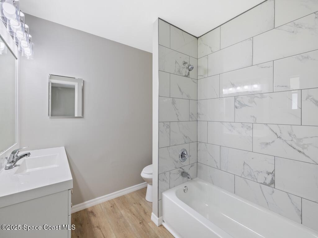 274 Trilby Road Southwest Palm Bay, FL 32908 - Photo 21 of 38 a white bath tub sitting next to a white sink and vanity