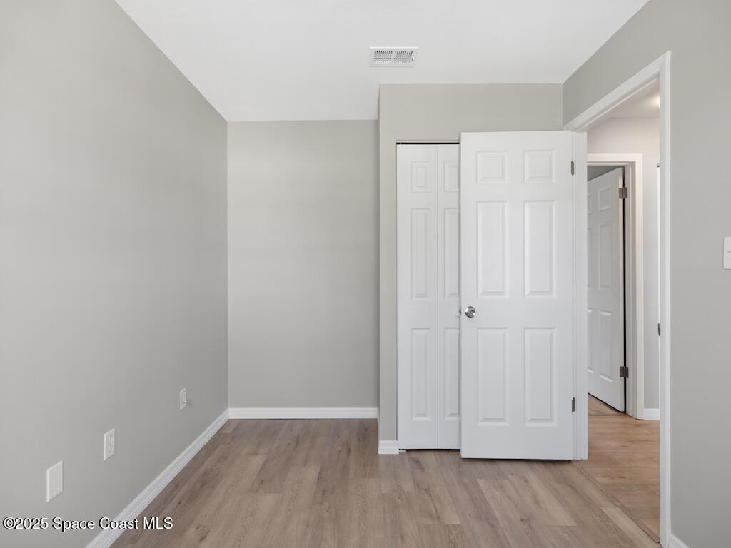 274 Trilby Road Southwest Palm Bay, FL 32908 - Photo 25 of 38 a view of an empty room with wooden floor