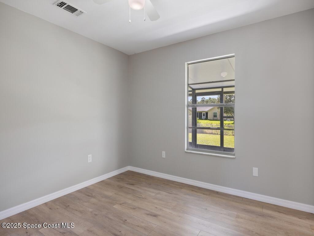 274 Trilby Road Southwest Palm Bay, FL 32908 - Photo 28 of 38 an empty room with windows and closet