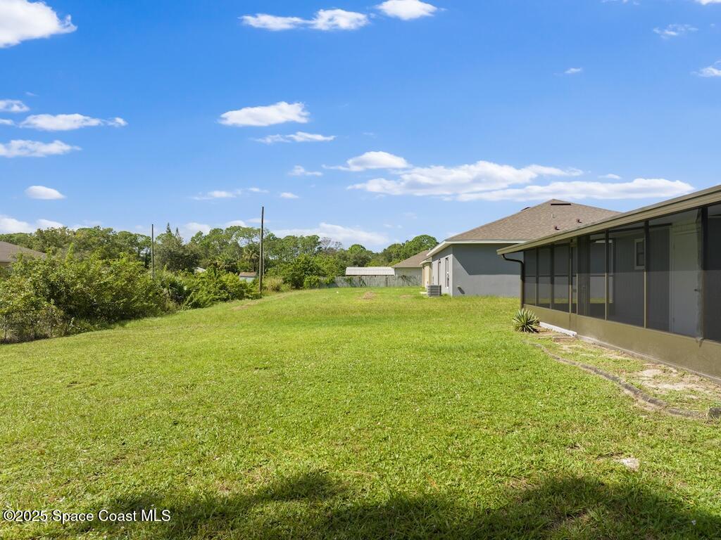 274 Trilby Road Southwest Palm Bay, FL 32908 - Photo 33 of 38 a backyard of a house with lots of green space