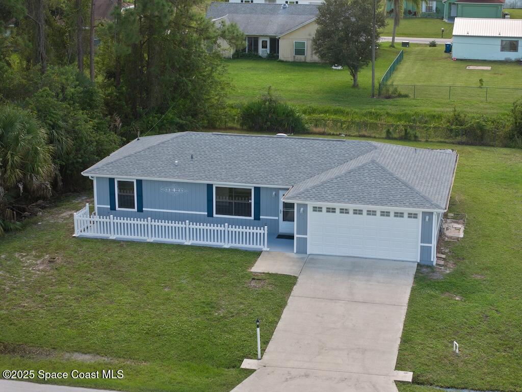 274 Trilby Road Southwest Palm Bay, FL 32908 - Photo 34 of 38 a aerial view of a house next to a yard with big trees