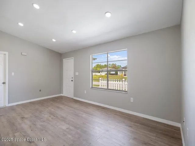 a view of an empty room with a window
