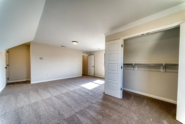 an empty room with closet area