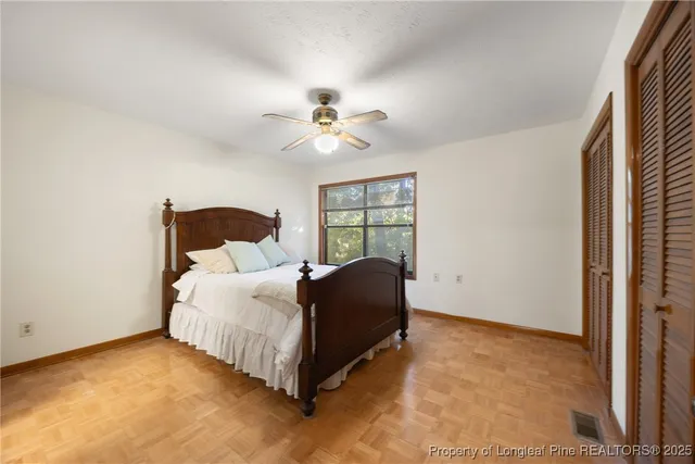 a spacious bedroom with a bed and a window