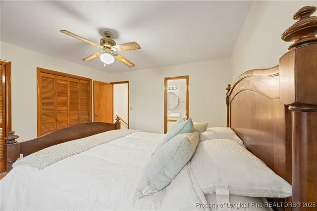 a bedroom with a large bed and wooden floor