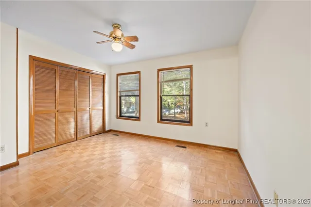 an empty room with windows and closet
