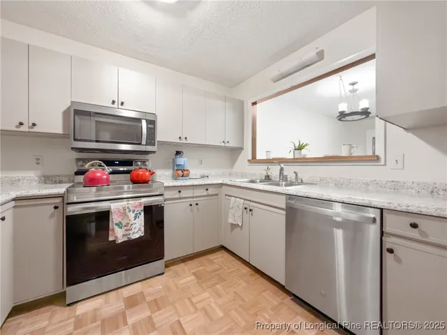 a kitchen with granite countertop cabinets and stainless steel appliances