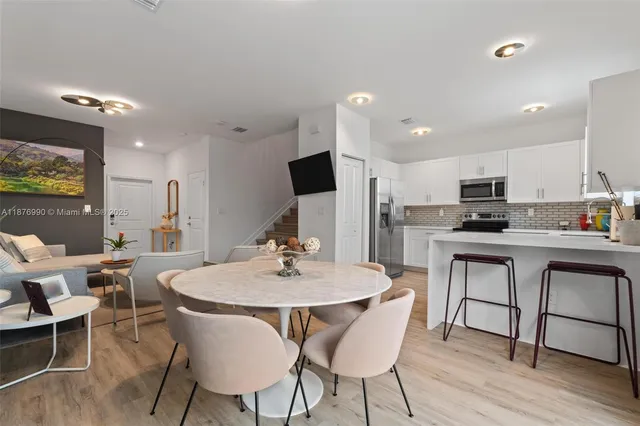 a kitchen with cabinets stainless steel appliances and a sink