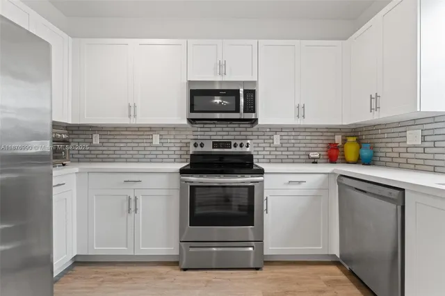 a kitchen with a refrigerator a stove and a refrigerator