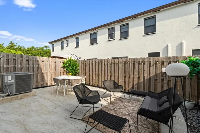 a view of a chairs and tables in the back yard of the house