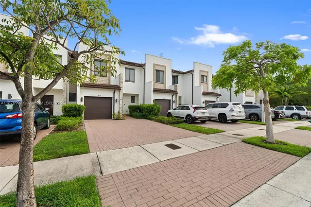 a view of a street with cars parked