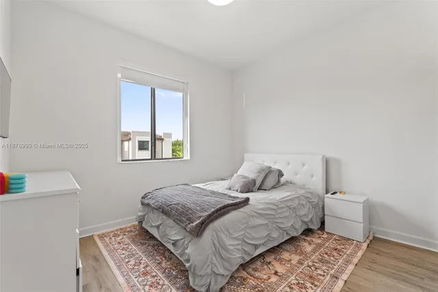 an aerial view of a houses with street
