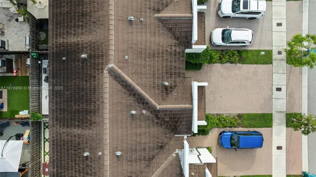 an aerial view of multiple houses with yard