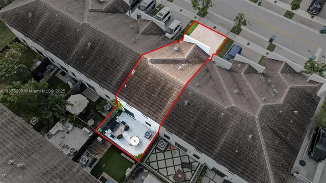 an aerial view of residential houses with outdoor space and swimming pool