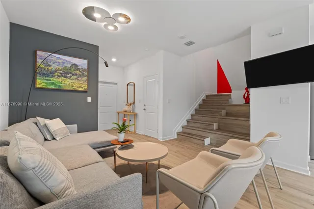 a view of hallway with stairs and wooden floor
