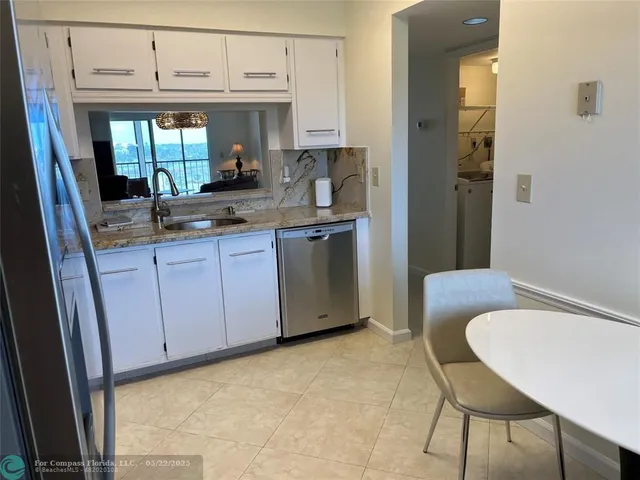 a kitchen with stainless steel appliances granite countertop a sink and cabinets