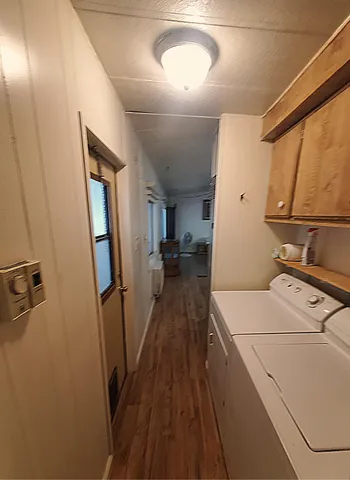 a view of a hallway with a washer and dryer