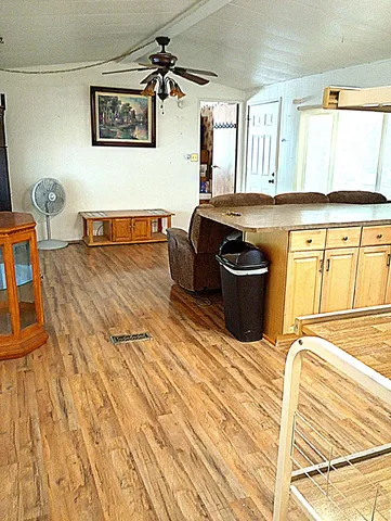 a living room with a couch and wooden floor