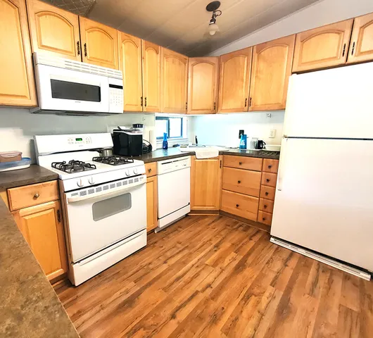 a kitchen with a stove a sink and a microwave