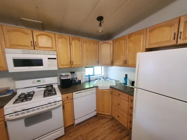 a kitchen with cabinets appliances and a sink