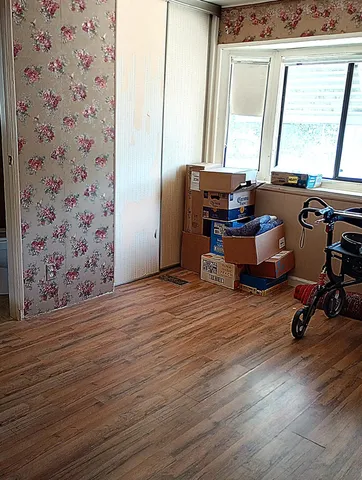 a room with wooden floor and furniture