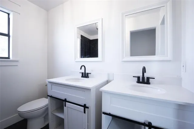 a bathroom with a toilet sink and mirror