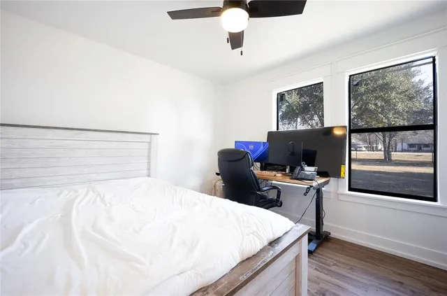 a bedroom with a bed and a desk