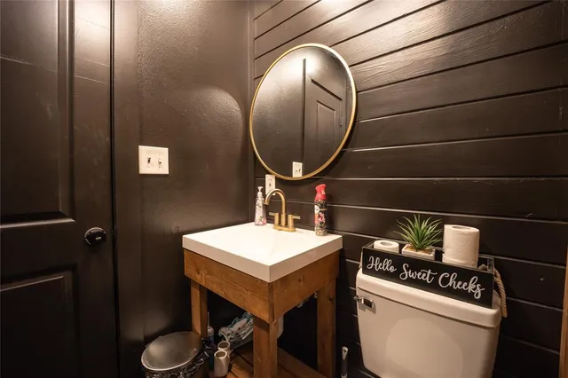 a bathroom with a toilet a sink and a mirror