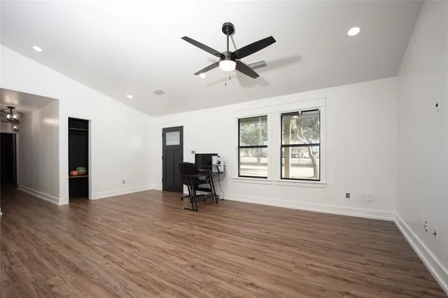 a view of a livingroom with a hardwood floor and a ceiling fan
