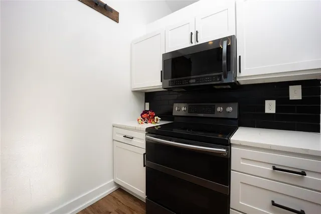 a kitchen with a stove and a microwave