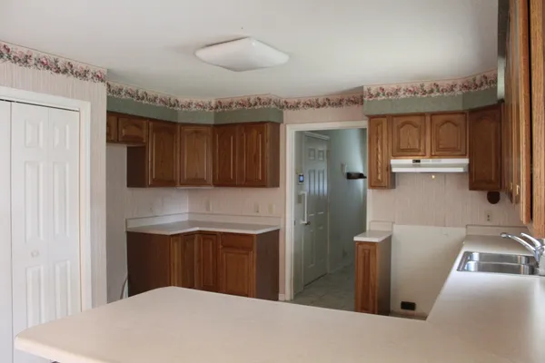a kitchen with stainless steel appliances granite countertop a sink and cabinets