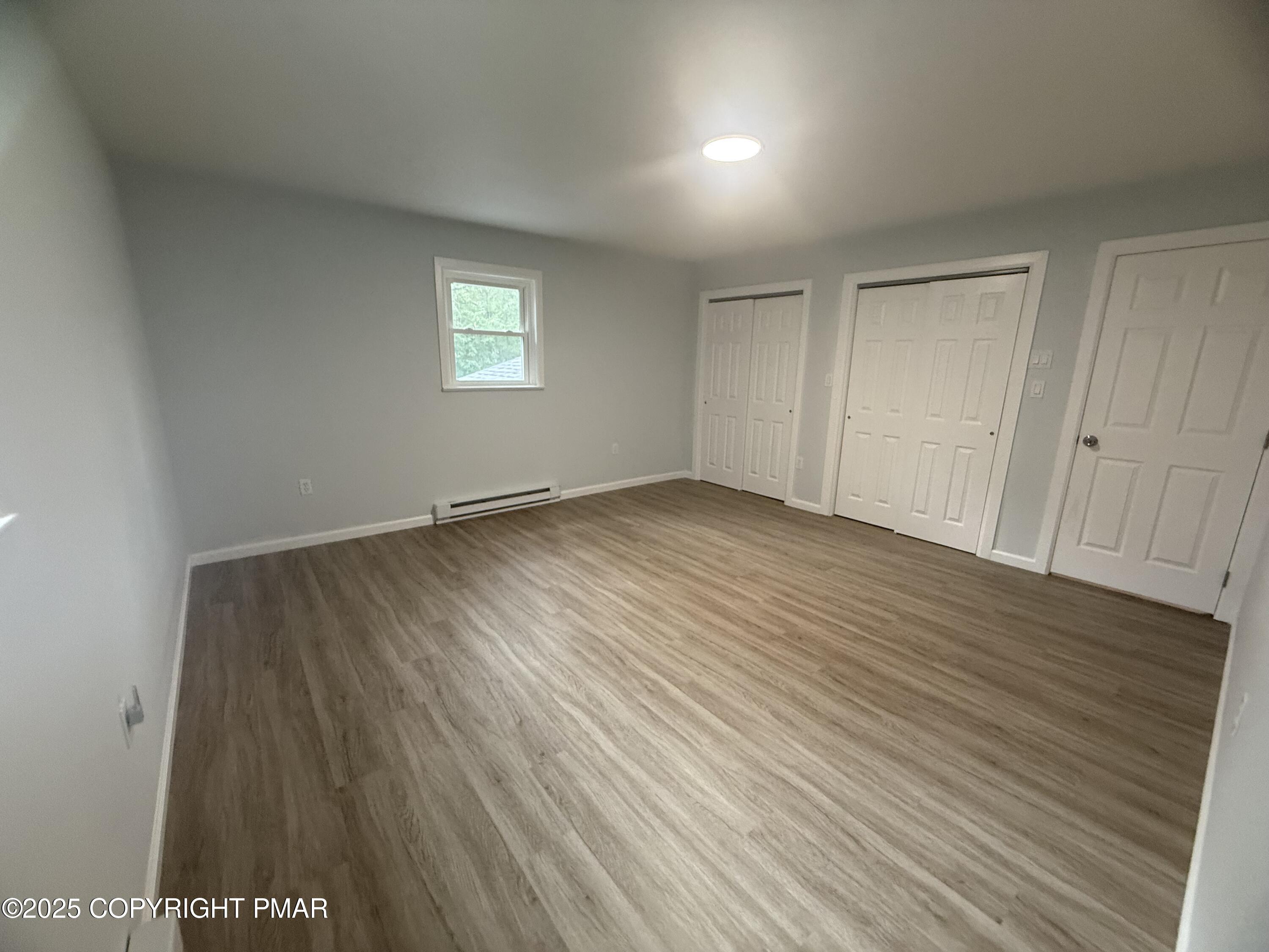 37 Seneca Road Mount Pocono, PA 18344 - Photo 18 of 46 a view of an empty room with wooden floor and a window