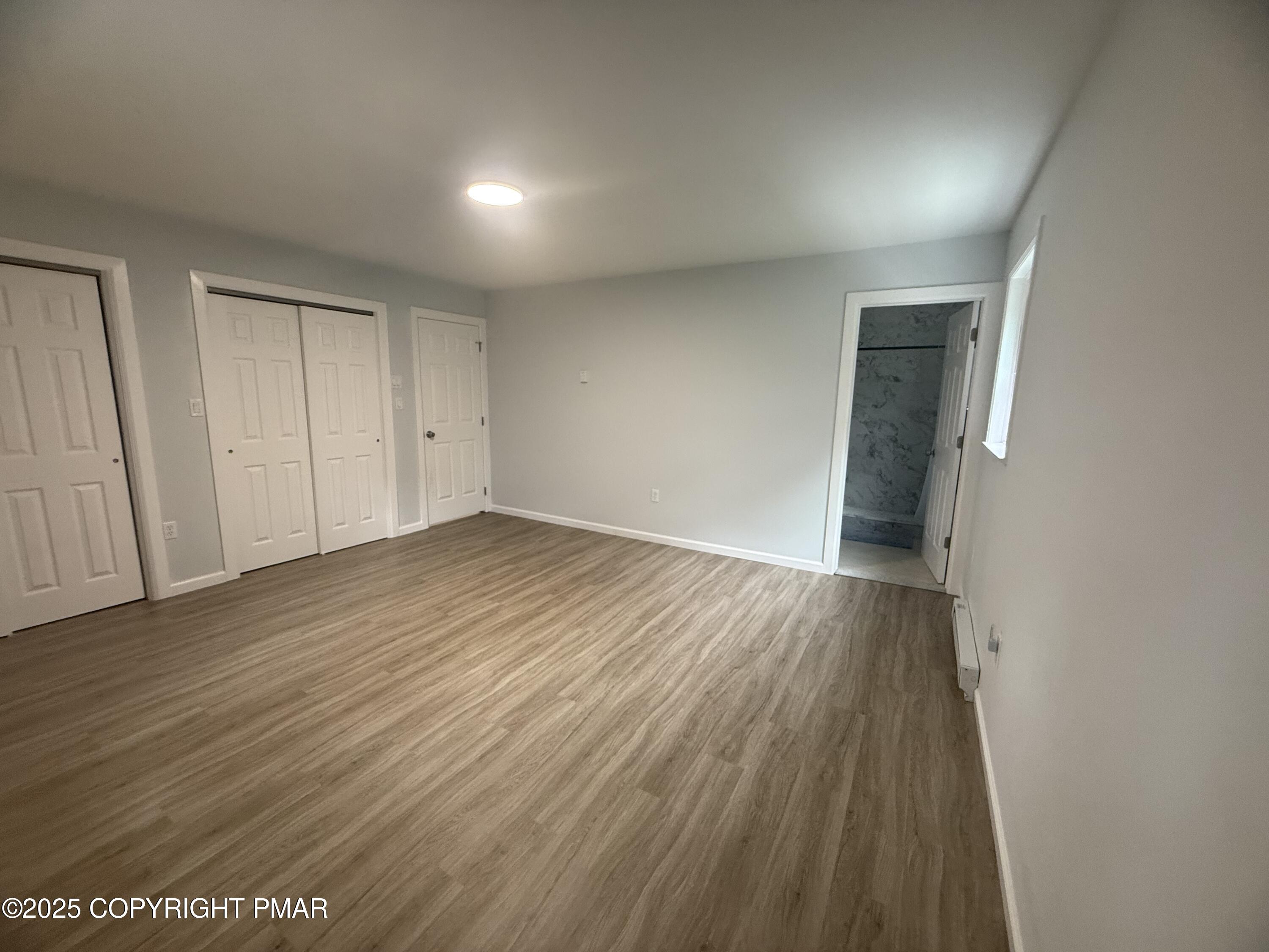 37 Seneca Road Mount Pocono, PA 18344 - Photo 19 of 46 a view of an empty room with wooden floor and closet