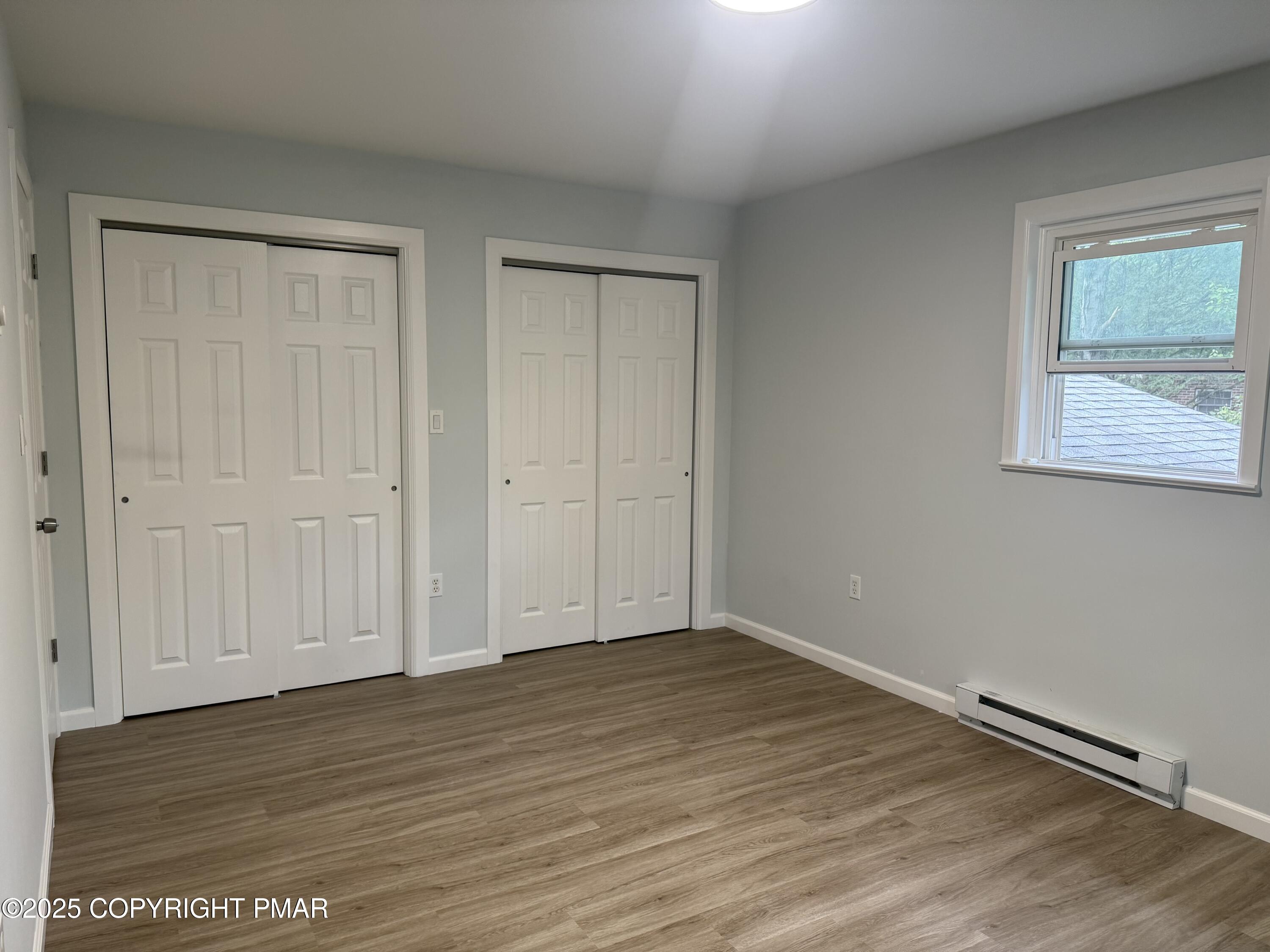 37 Seneca Road Mount Pocono, PA 18344 - Photo 23 of 46 a view of an empty room with wooden floor and a window