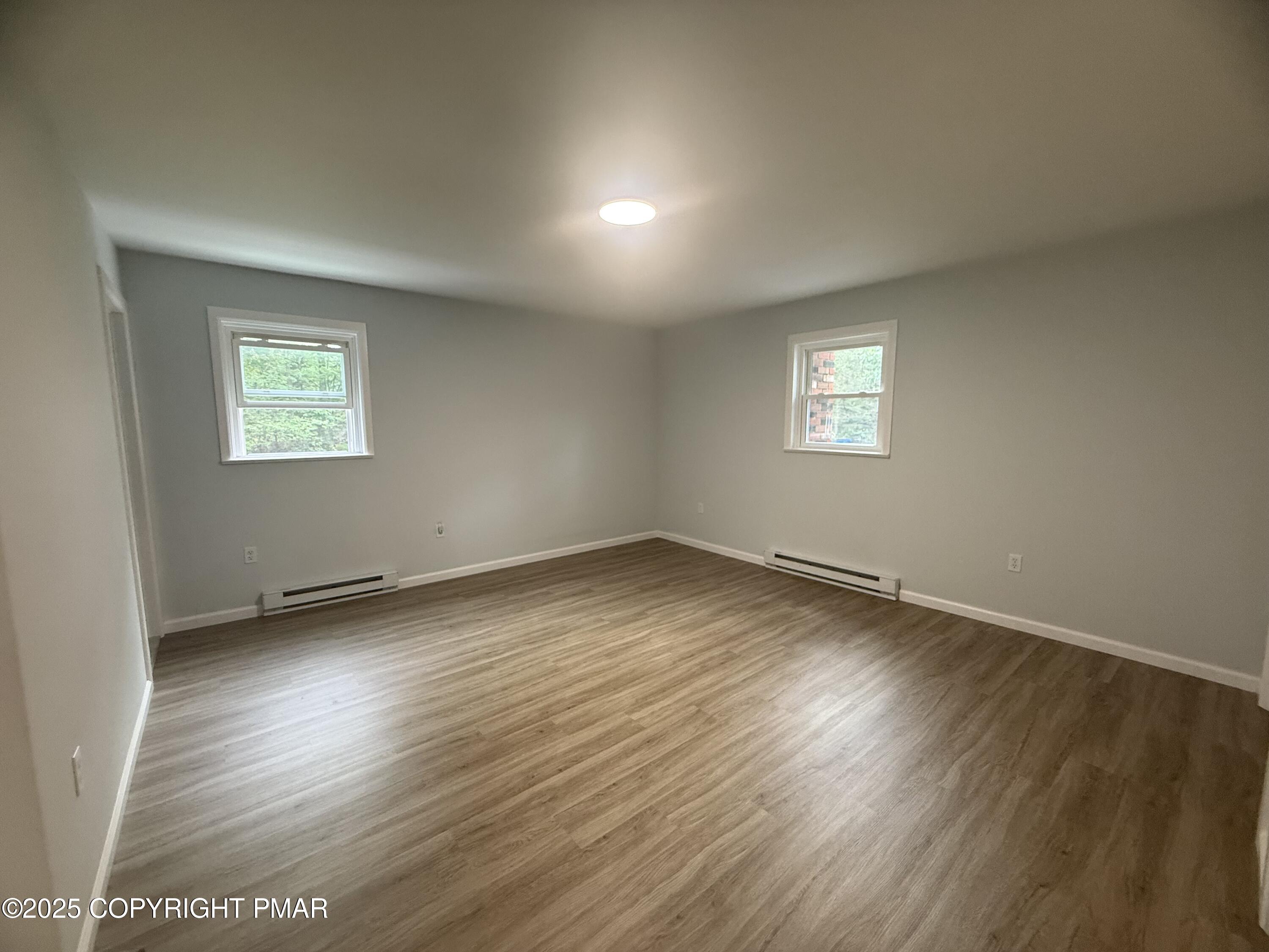 37 Seneca Road Mount Pocono, PA 18344 - Photo 24 of 46 an empty room with wooden floor and windows