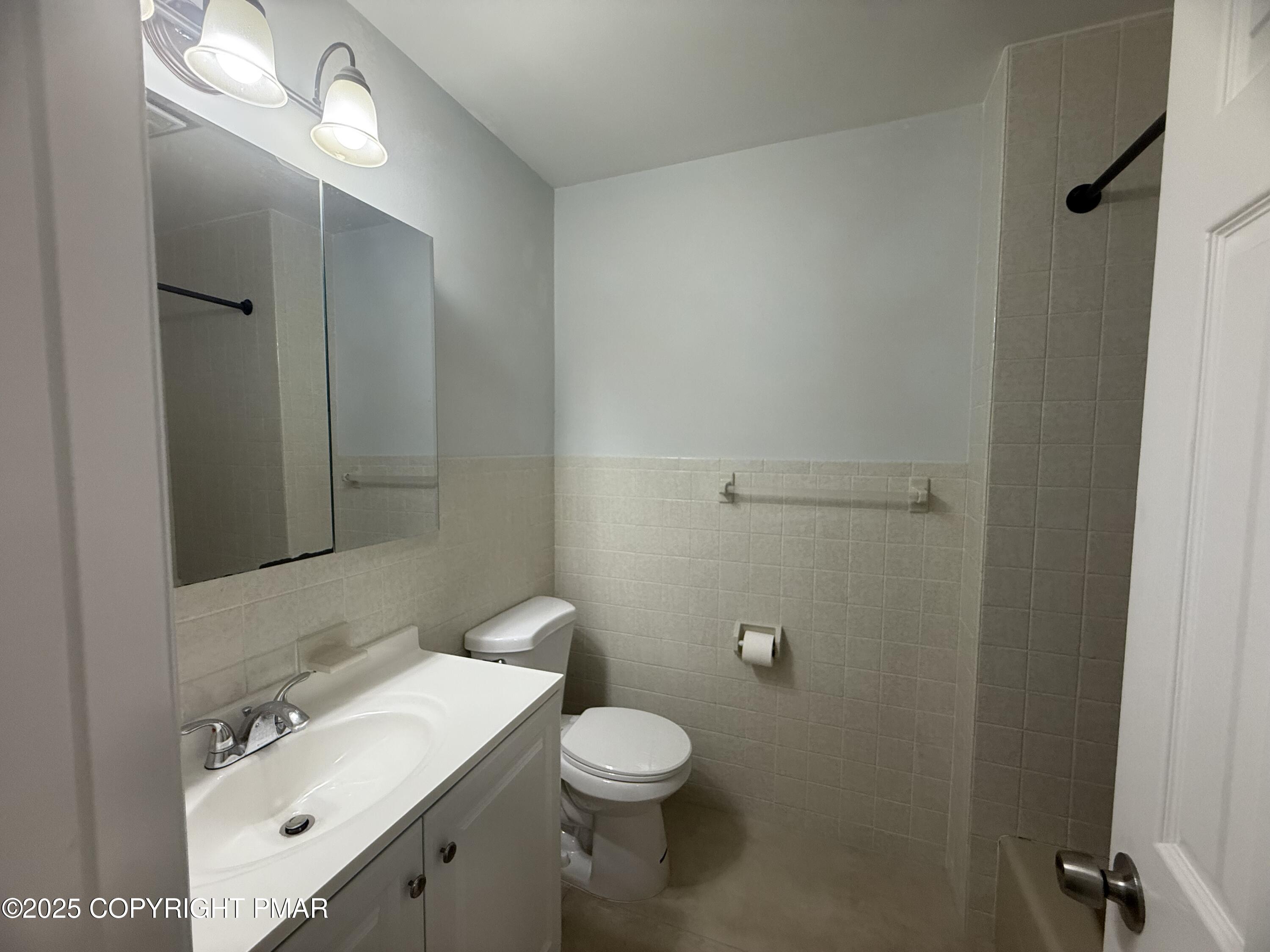 37 Seneca Road Mount Pocono, PA 18344 - Photo 26 of 46 a bathroom with a toilet a sink and mirror