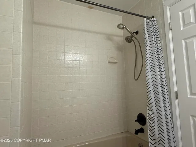 a bathroom with a shower and a shower