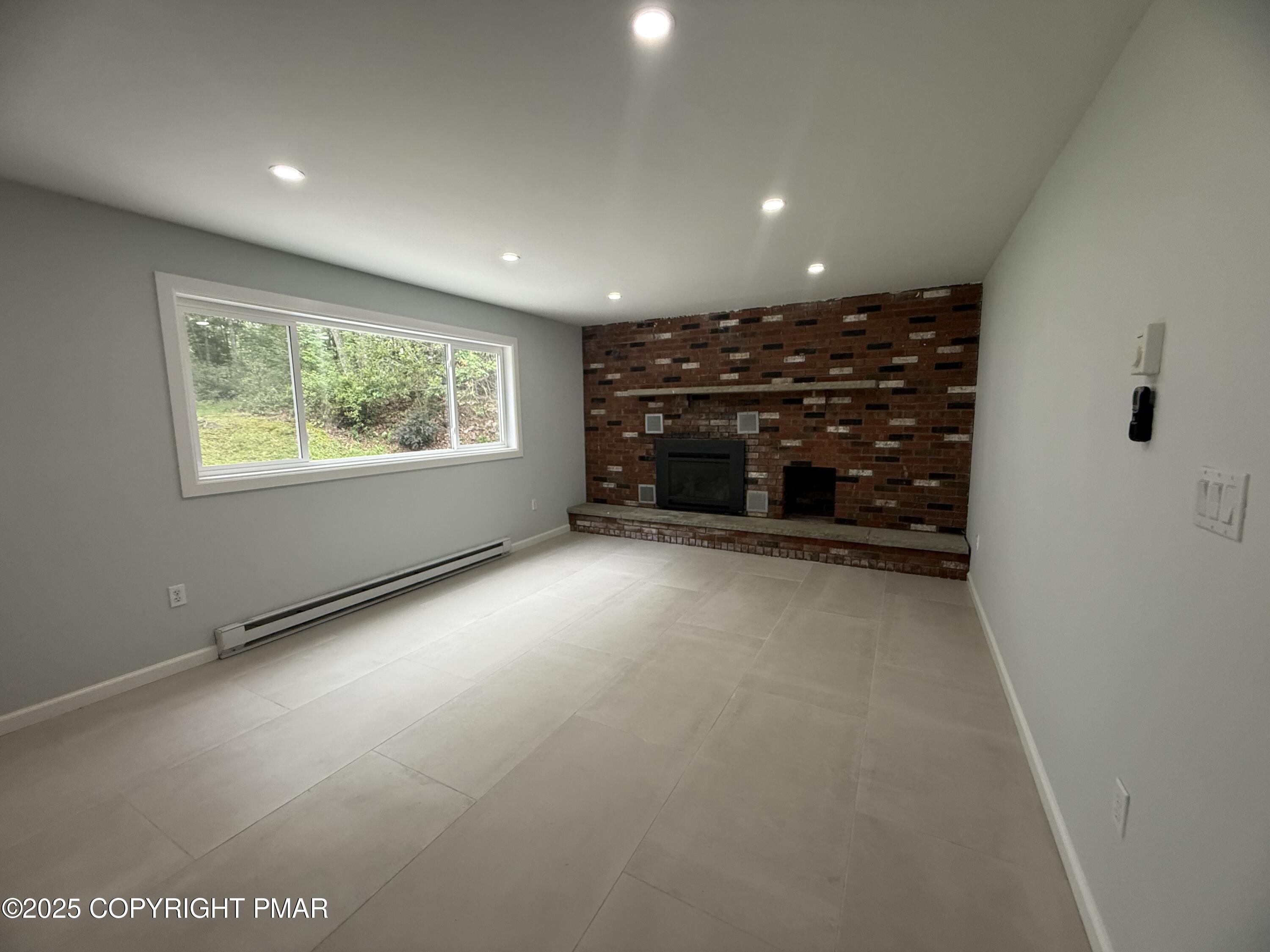 37 Seneca Road Mount Pocono, PA 18344 - Photo 32 of 46 a view of an empty room with a fireplace and a window