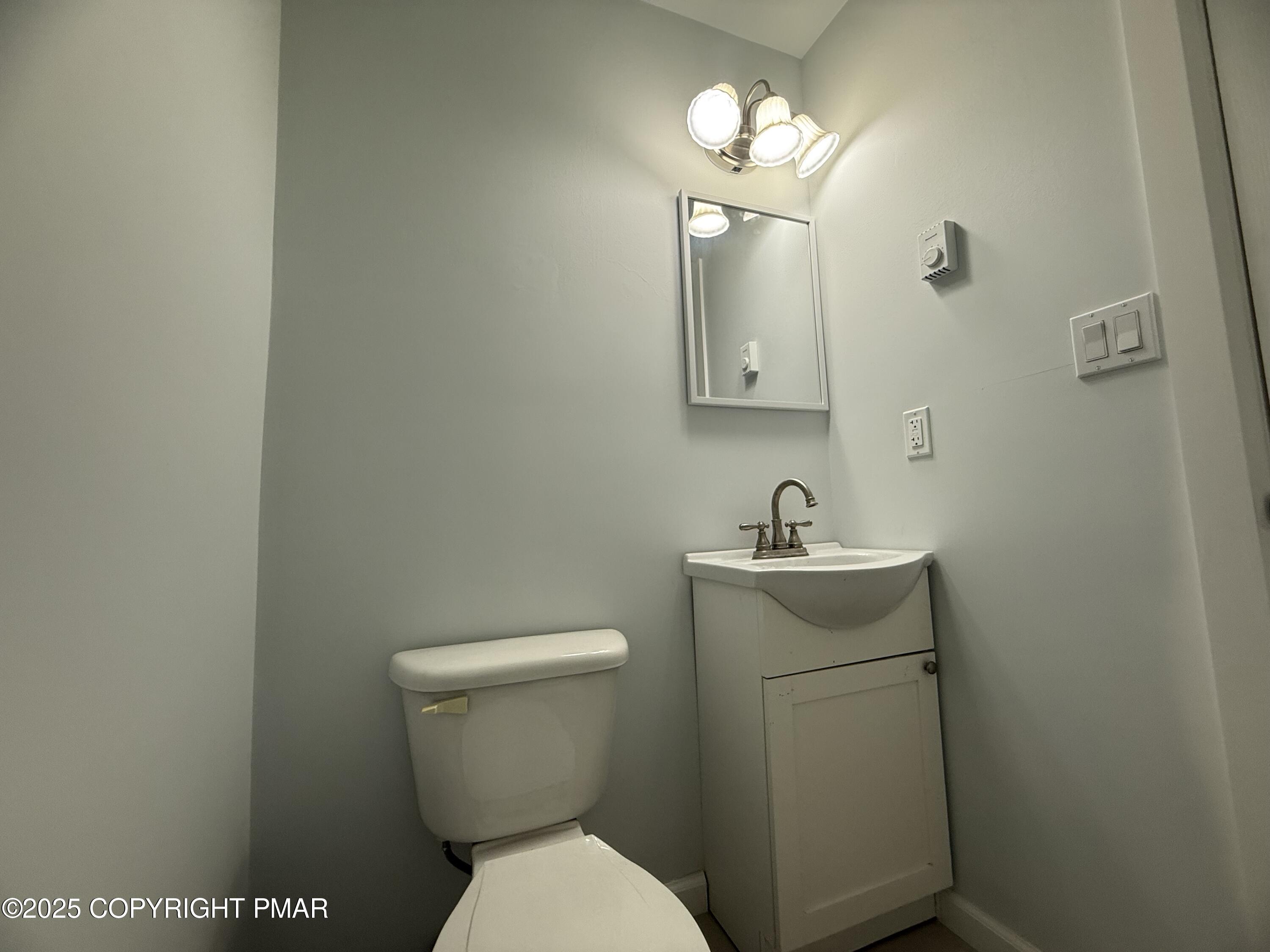 37 Seneca Road Mount Pocono, PA 18344 - Photo 34 of 46 a bathroom with a toilet a sink and mirror