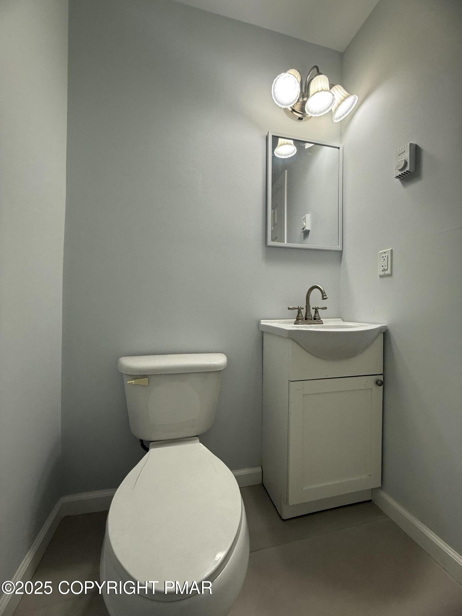 37 Seneca Road Mount Pocono, PA 18344 - Photo 35 of 46 a bathroom with a toilet sink and mirror