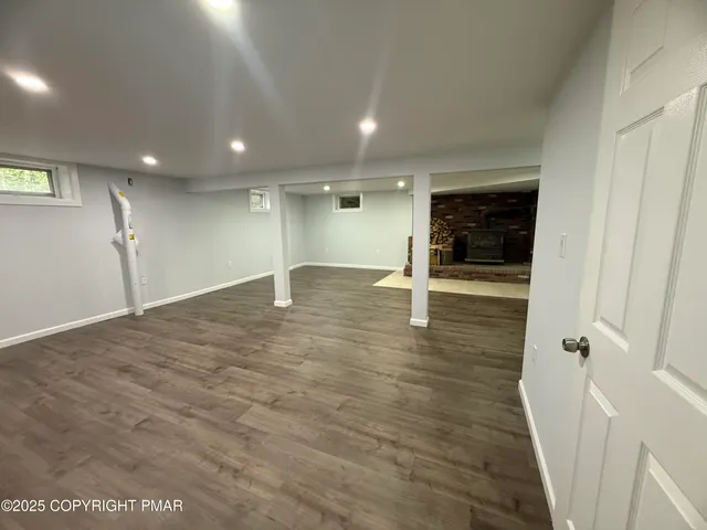 an empty room with wooden floor and entrance